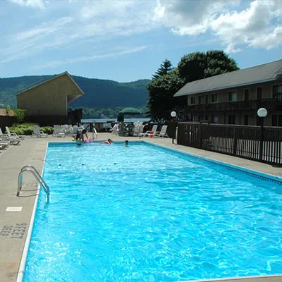 In-ground pool with lake and mountain views