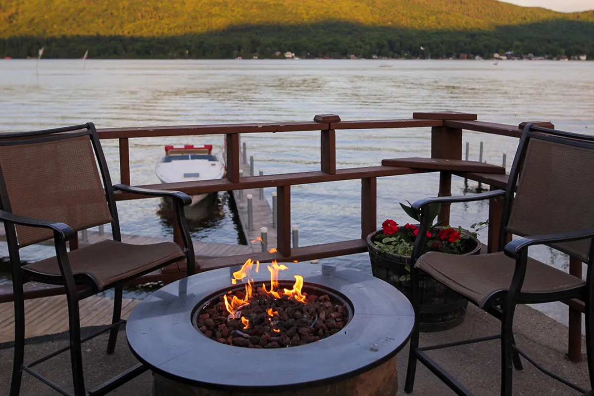 Fire pit on the deck by Lake George waters edge